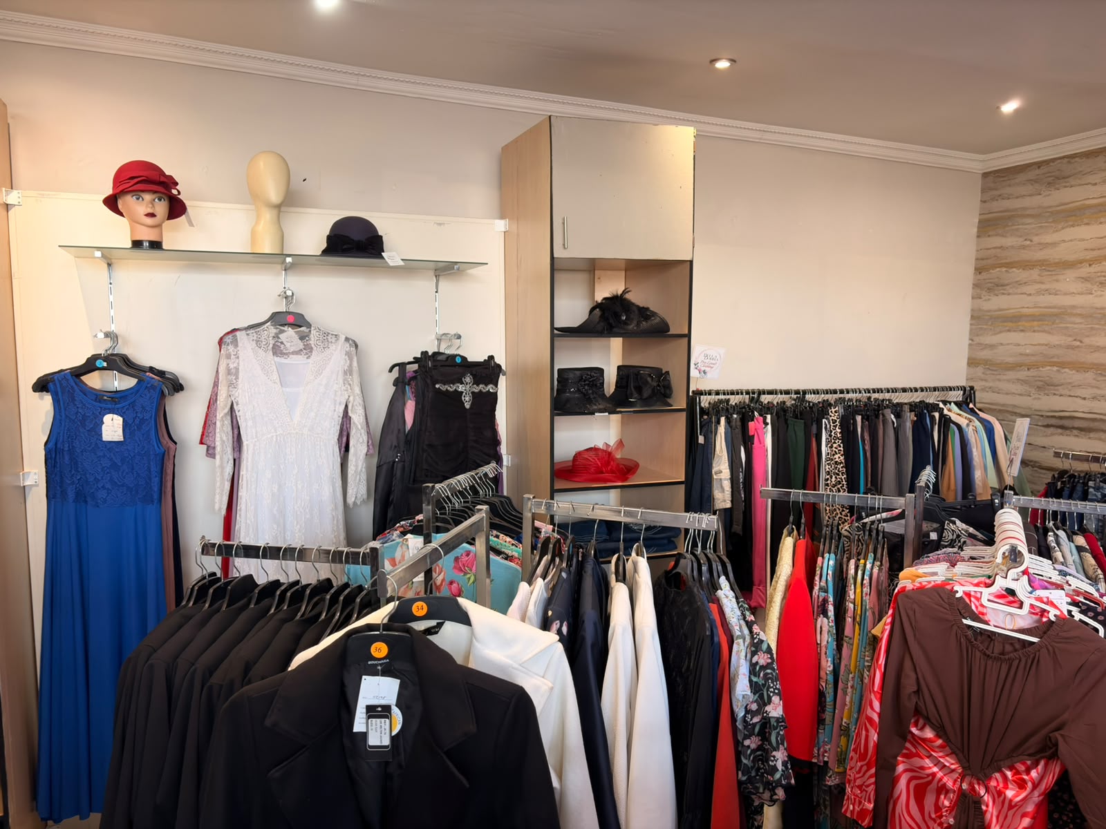 Occasion dresses displayed with hats