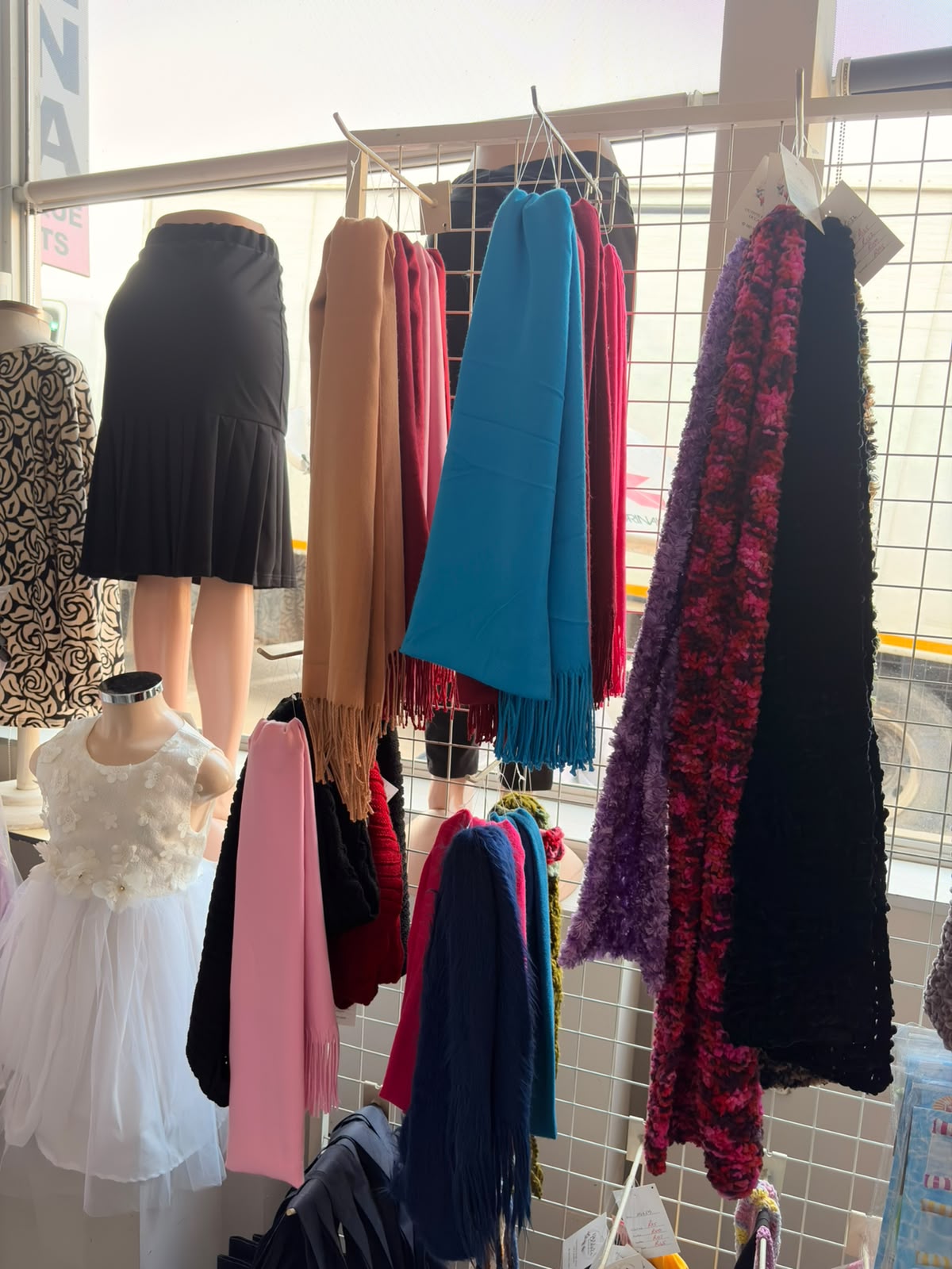 Scarves, skirts and knitwear display